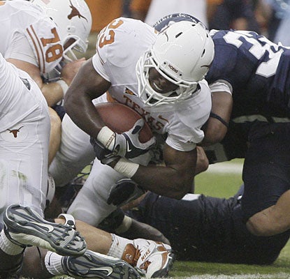 Despite losing the starting job, Tre' Newton barrels his way through for one of his three TDs.  (AP)