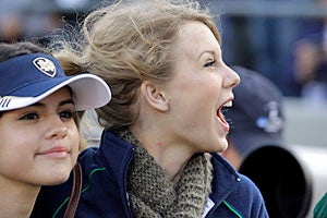 Instead of being a distraction in the student section, Taylor Swift gets a closer look from the sideline. (AP)