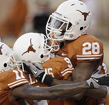 Fozzy Whittaker (28) of Texas celebrates with teammates after scoring in the second quarter.  (AP)
