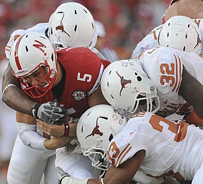 Nebraska's Zac Lee, who replaced Taylor Martinez, is swarmed over by Longhorns.  (AP)