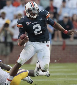 Auburn QB Cameron Newton runs for 217 yards in a 24-17 win over LSU. (AP)