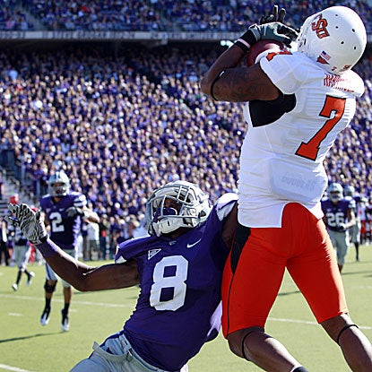 Oklahoma State's Michael Harrison (7) catches a TD pass as K-State's Stephen Harrison defends.   (AP)