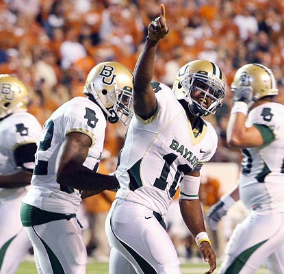 Robert Griffin III celebrates one of his three touchdowns as he helps Baylor earn a massive win over Texas. (AP)