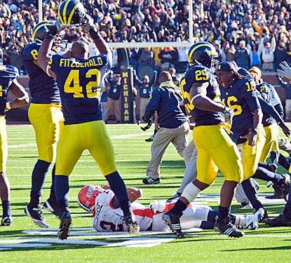 Michigan's defense can celebrate after stopping Nathan Scheelhaase's try at a game-tying two-point conversion.  (AP)