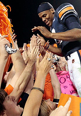 QB Cam Newton revels in the adoration of Auburn faithful after the Tigers beat Georgia on Saturday. (AP)
