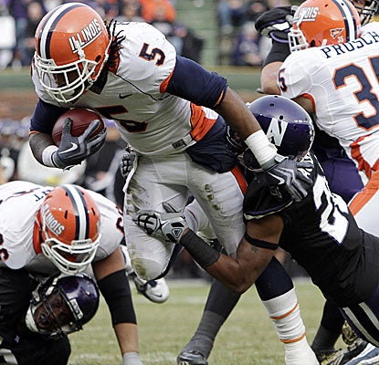 Northwestern's Justan Vaughn tries to contain Illinois' Mikel Leshoure but the running back ends up with 330 yards. (AP)