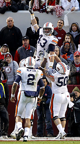 Auburn's Philip Lutzenkirchen celebrates his TD with Ryan Pugh (50), Cam Newton (2),  Mike Berry. (AP)