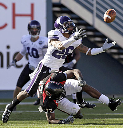 Northwestern's Jordan Mabin intercepts a pass intended for Texas Tech's Detron Lewis. (AP)