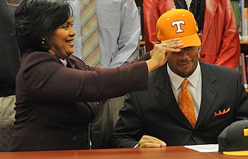 The hat doesn't always fit the same for proud parents and prized recruits. (AP)