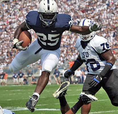Silas Redd goes airborne to avoid a tackler while picking up some of his 104 rushing yards.  (US Presswire)