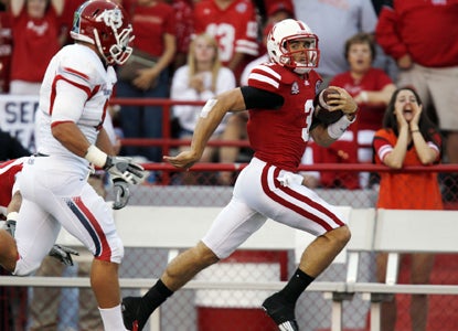 Cornhusker QB Taylor Martinez (right) throws for 219 yards and runs for 166 more before finishing with three TD's.  (Getty Images)