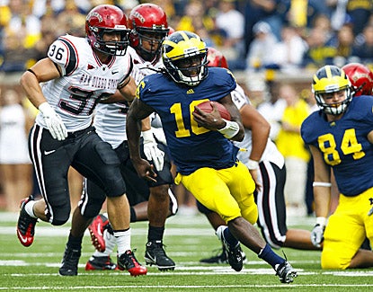 Michigan's Denard Robinson runs for extra yardage against San Diego State. Robinson scores three touchdowns in the win. (US Presswire)