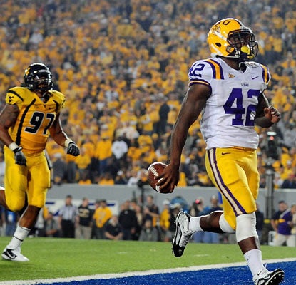 LSU's Michael Ford leaves West Virginia behind with two rushing touchdowns in the Tigers' impressive win.  (US Presswire)