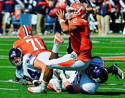 Illinois quarterback Nathan Scheelhaase tries to avoid being sacked. His score with 13 seconds left lifts Illinois to a win. (US Presswire)