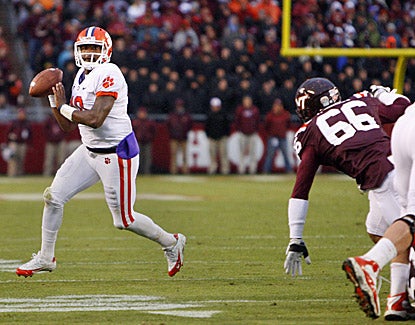 Tajh Boyd looks to pass as Virginia Tech's Tyrel Wilson (66) chases. Boyd passes for a score and 204 yards in the Tigers' win. (US Presswire)