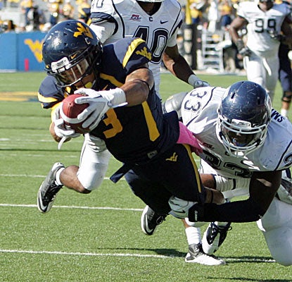 West Virginia's Stedman Bailey dives for the end zone to complete one of Geno Smith's four touchdown passes.  (US Presswire)