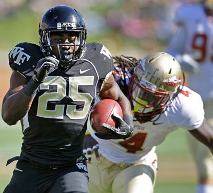 Josh Harris gouges the ACC's top run defense for gains of 42 and 57 yards to set up Wake Forest touchdowns.  (AP)