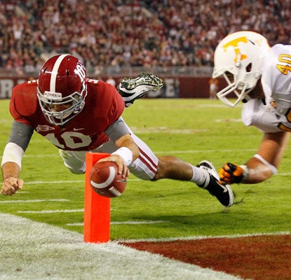 AJ McCarron dives for his one rushing touchdown and adds another through the air to keep Alabama on track for LSU.  (Getty Images)