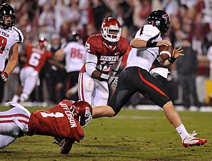 Texas Tech QB Seth Doege eludes defenders on the way to five total TDs and a huge upset over No. 3 Oklahoma. (US Presswire)