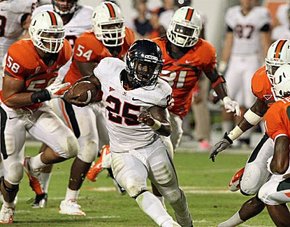 Virginia  running back Kevin Parks breaks free from Miami defenders in the third quarter of the Cavaliers' 28-21 win. (US Presswire)