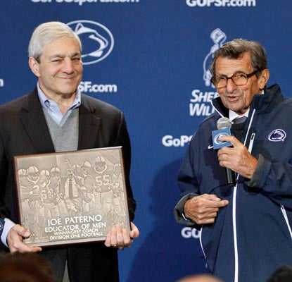 Joe Paterno receives a plaque after earning the 409th victory of his legendary coaching career.  (Getty Images)