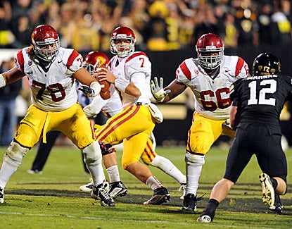 Matt Barkley (center) throws a school-record six touchdowns in No. 21 USC's 42-17 win over Colorado. (US Presswire)