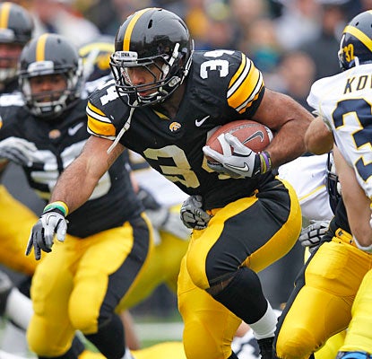 Marcus Coker does the heavy lifting for Iowa, gaining 132 yards and scoring two touchdowns.  (Getty Images)