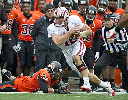 Stanford's Andrew Luck, who throws for three TDs against Oregon State, avoids Scott Crichton and picks up a first down. (US Presswire)