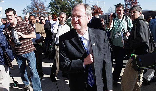 Penn State SID Jeff Nelson walks away from the media after saying Paterno wouldn't speak. (US Presswire)