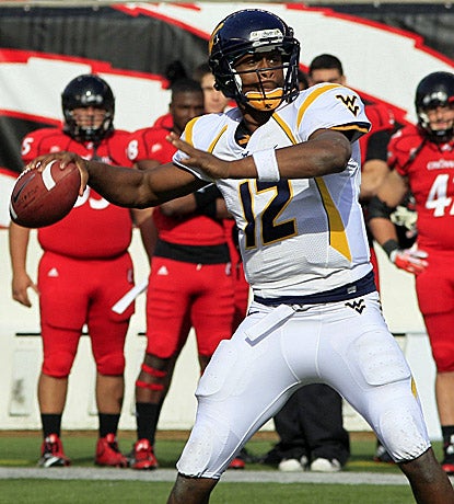 Geno Smith, who throws for 372 yards and a score, leads WVU on a game-clinching drive to knock off No. 23 Cincinnati. (AP)