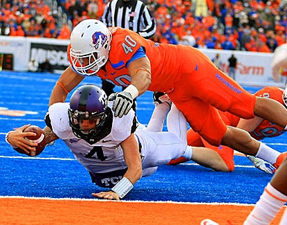TCU quarterback Casey Pachall (4) runs in for the winning two-point conversion under Boise State's Tyrone Crawford. (US Presswire)
