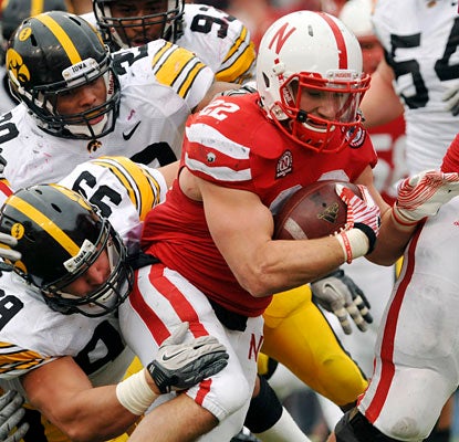 Days after shedding a walking boot, Rex Burkhead gains 160 yards and scores once on a school-record 38 carries.  (AP)