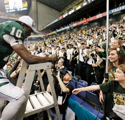 Robert Griffin III celebrates what might be his final game with Baylor fans after a thrilling Alamo Bowl.  (AP)