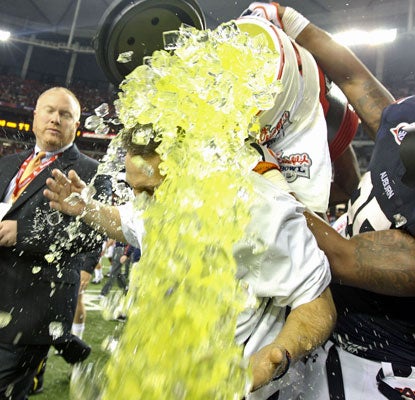 Auburn players douse coach Gene Chizik following a convincing victory in the Chick-fil-A Bowl.  (US Presswire)