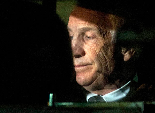 Placed in a squad car Friday night, Sandusky is headed for jail until his sentencing hearing. (US Presswire)