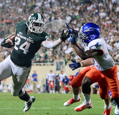 Le'Veon Bell stiff-arms a Boise State defender on his way to a touchdown in the fourth quarter.  (US Presswire)