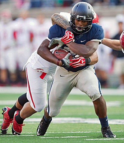 Utah State's Kerwynn Williams rushes for 95 yards and scores on a one-yard run on the first possession of overtime. (US Presswire)