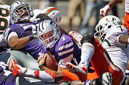Collin Klein, who rushes for three TDs and throws for another, looks for an official's call after crossing the goal line. (AP)