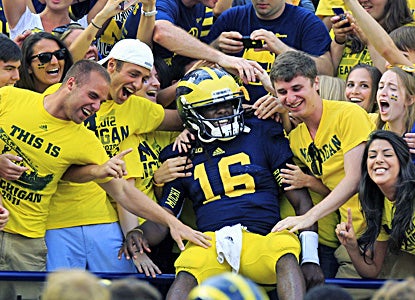 Denard Robinson celebrates after accounting for four touchdowns in Michigan's win over the Air Force. (AP)