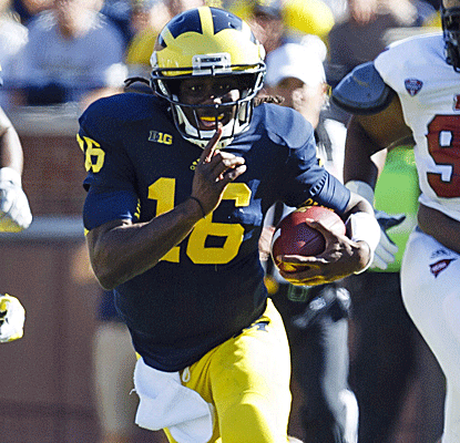 Michigan QB Denard Robinson slices up UMass, accounting for four touchdowns and nearly 400 total yards.  (US Presswire)