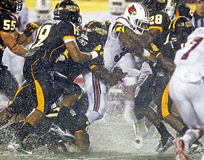 Senorise Perry rushes for 118 yards and two touchdowns in Louisville's win over Southern Mississippi. (AP)