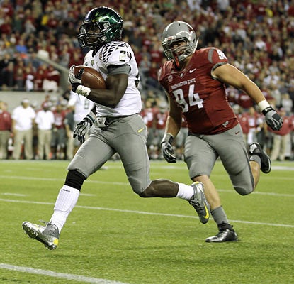 Kenjon Barner rumbles for 195 yards and three touchdowns on 20 carries to average a whopping 9.8 yards per attempt. (AP)