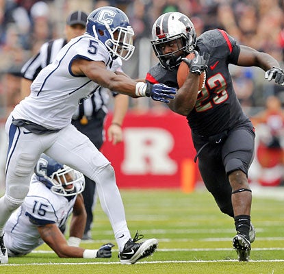 Jawan Jamison helps Rutgers control the ball against UConn, rushing for 110 yards on 28 carries.  (US Presswire)