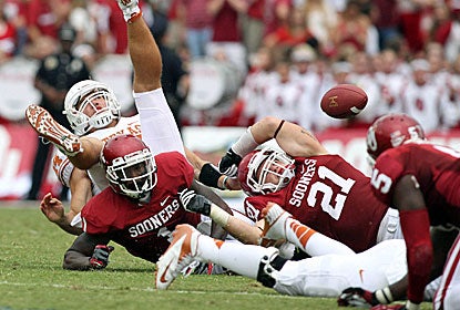 Texas Longhorns quarterback David Ash (14) fumbles the ball in the third quarter against the Oklahoma Sooners. (US Presswire)