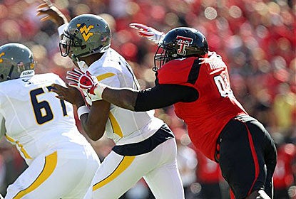 Geno Smith throws under pressure from Texas Tech's Kerry Hyder. Smith throws for 275 yards, but just one touchdown.   (AP)