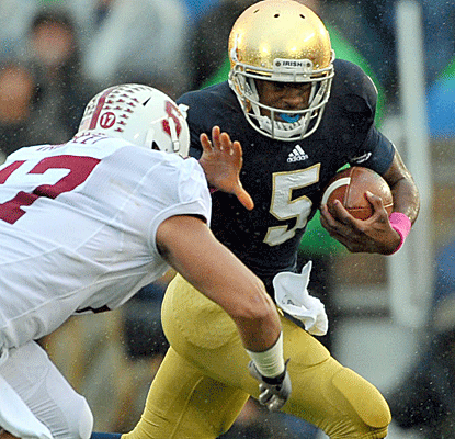 Quarterback Everett Golson and the Notre Dame offense struggle to score, but get the TD that counts in overtime.  (US Presswire)