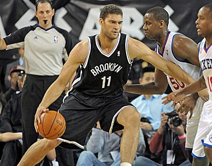 Brooklyn Nets center Brook Lopez drives against Philadelphia forward Lavoy Allen (50) in their game in Atlantic City. (US Presswire)