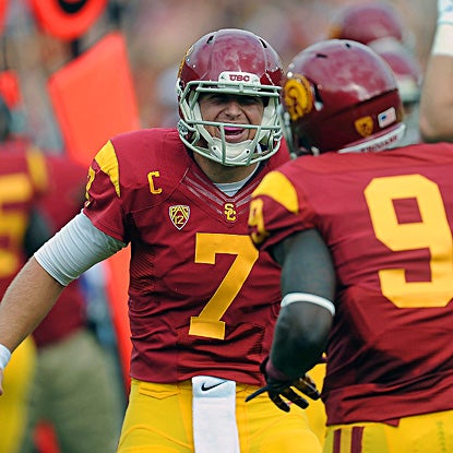 Matt Barkley celebrates with Marqise Lee following one of Barkley's five first-half touchdowns. He finishes with six. (US Presswire)