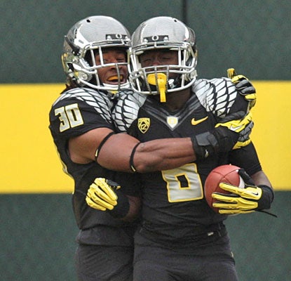Ayele Forde helps De'Anthony Thomas celebrate after his electric 73-yard punt return for a touchdown  (US Presswire)