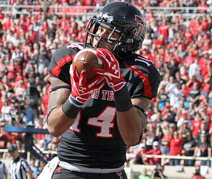 Darrin Moore hauls in a game-winning touchdown in double overtime to lead Texas Tech to its seventh win of the season. (US Presswire)